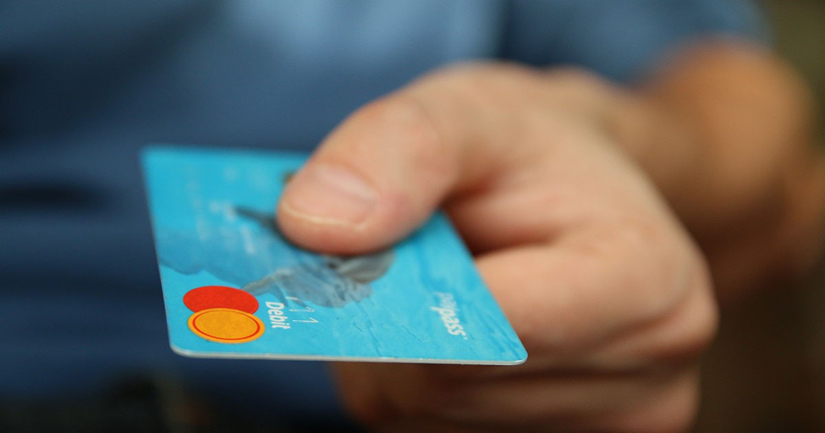 person holding credit card